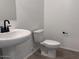 Bathroom featuring a pedestal sink and toilet with modern fixtures at 47253 W Pecan Woods --, Maricopa, AZ 85139