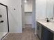 Bathroom with tiled floors, gray vanity with light countertop, and glass shower stall at 47253 W Pecan Woods --, Maricopa, AZ 85139