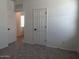 Bright bedroom showcasing neutral walls and soft carpeting, adjacent to multiple doorways at 47253 W Pecan Woods --, Maricopa, AZ 85139