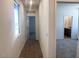 Well-lit hallway boasting hardwood flooring and easy access to bedrooms and bathrooms at 47253 W Pecan Woods --, Maricopa, AZ 85139