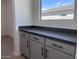 Kitchen with gray cabinets and black hardware, and view from the window at 47253 W Pecan Woods --, Maricopa, AZ 85139