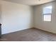 Bright living room area with tile floors and a window at 47253 W Pecan Woods --, Maricopa, AZ 85139
