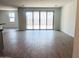 Bright living room with sliding glass doors and wood-look tile flooring at 47253 W Pecan Woods --, Maricopa, AZ 85139