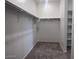 Walk-in closet featuring shelving, hanging racks and carpet at 47253 W Pecan Woods --, Maricopa, AZ 85139