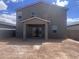 View of the house's exterior with covered patio and large backyard with desert landscape at 47748 W Moeller Rd, Maricopa, AZ 85139