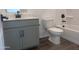 Bathroom boasts modern vanity with dark fixtures and a white toilet and shower at 47748 W Moeller Rd, Maricopa, AZ 85139