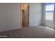 Cozy bedroom provides a window view and closet entrance at 47748 W Moeller Rd, Maricopa, AZ 85139
