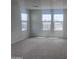 A bright bedroom with large windows offering neighborhood views and plush carpet at 47748 W Moeller Rd, Maricopa, AZ 85139