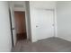 Bedroom with gray carpet, neutral walls, walk-in closet with sliding doors, and a view into the hall at 47748 W Moeller Rd, Maricopa, AZ 85139