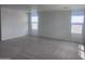 A large bedroom with three windows and plush carpet at 47748 W Moeller Rd, Maricopa, AZ 85139