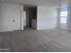 A large bonus room with plush carpet and natural light at 47748 W Moeller Rd, Maricopa, AZ 85139