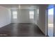 A spacious living room is brightened by two windows and a sliding glass door at 47748 W Moeller Rd, Maricopa, AZ 85139