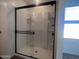 Walk-in shower featuring sleek glass doors and built-in shelving at 47748 W Moeller Rd, Maricopa, AZ 85139