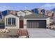 Charming single-story home with desert landscaping and a two-car garage, set against a backdrop of majestic mountains at 4939 S 106Th Ave, Tolleson, AZ 85353