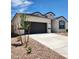 Charming single-story home featuring a gray garage door, neutral stucco and simple desert landscaping at 4939 S 106Th Ave, Tolleson, AZ 85353
