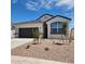 Charming single-story home featuring a gray garage door, neutral stucco and simple desert landscaping at 4939 S 106Th Ave, Tolleson, AZ 85353