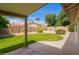 Well-maintained backyard with lush green lawn, landscaping, covered patio, and privacy fence at 5011 E Nisbet Rd, Scottsdale, AZ 85254