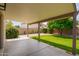 Spacious backyard features covered patio, manicured lawn, rock groundcover, and mature landscaping at 5011 E Nisbet Rd, Scottsdale, AZ 85254