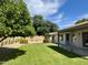 Lush backyard features a green lawn, mature citrus tree and covered patio area at 5011 E Nisbet Rd, Scottsdale, AZ 85254