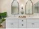 Bathroom featuring a double vanity with sconces and a decorative mirror at 5011 E Nisbet Rd, Scottsdale, AZ 85254