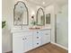 Stylish bathroom with a double vanity, dual decorative mirrors, and walk-in shower at 5011 E Nisbet Rd, Scottsdale, AZ 85254
