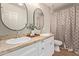 Bright bathroom features double sinks, granite countertops, and a decorative shower curtain at 5011 E Nisbet Rd, Scottsdale, AZ 85254