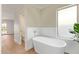Modern bathroom featuring a freestanding soaking tub with a large window at 5011 E Nisbet Rd, Scottsdale, AZ 85254