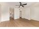 Spacious bedroom with wood-look floors, ceiling fan, and double closets at 5011 E Nisbet Rd, Scottsdale, AZ 85254