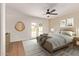 Bright bedroom featuring a ceiling fan, wood-look floors, and sliding doors leading to the outdoors at 5011 E Nisbet Rd, Scottsdale, AZ 85254