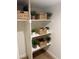 Organized closet offers ample storage with shelving and decorative woven baskets at 5011 E Nisbet Rd, Scottsdale, AZ 85254