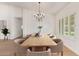 Beautifully staged dining room with a large table, chandelier, and bright, inviting atmosphere for entertaining at 5011 E Nisbet Rd, Scottsdale, AZ 85254