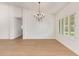 Elegant dining room boasts a chandelier, plantation shutters, and wood-look tile flooring for stylish meals at 5011 E Nisbet Rd, Scottsdale, AZ 85254