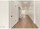 Bright hallway showcasing wood-look tile flooring and leading to the main entrance and other rooms at 5011 E Nisbet Rd, Scottsdale, AZ 85254