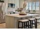 Bright kitchen features quartz island with seating, stainless steel appliances, and modern finishes at 5011 E Nisbet Rd, Scottsdale, AZ 85254