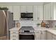 Close-up of the kitchen with stainless steel appliances and white countertops and cabinets at 5011 E Nisbet Rd, Scottsdale, AZ 85254