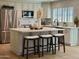 Bright kitchen features quartz island with seating, stainless steel appliances, and modern finishes at 5011 E Nisbet Rd, Scottsdale, AZ 85254
