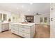 Kitchen island, white cabinets, white countertops, and open layout for cooking and entertaining at 5011 E Nisbet Rd, Scottsdale, AZ 85254