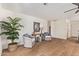 Sitting area showcasing two wicker chairs, wood floors, and a potted palm tree at 5011 E Nisbet Rd, Scottsdale, AZ 85254