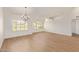 Spacious living room features wood-look tile, plantation shutters, and ample natural light for relaxation at 5011 E Nisbet Rd, Scottsdale, AZ 85254