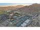 Scenic aerial view of the community featuring pools, tennis courts, and mountain views at 5233 N 207Th Dr, Buckeye, AZ 85396