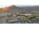 Beautiful aerial view showcasing community clubhouse and amenities with mountain views at 5233 N 207Th Dr, Buckeye, AZ 85396