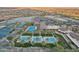 Beautiful aerial view of the community with multiple pools, tennis courts and golf course at 5233 N 207Th Dr, Buckeye, AZ 85396