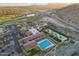 Beautiful aerial view of the community, with multiple pools, tennis courts, and lush landscaping at 5233 N 207Th Dr, Buckeye, AZ 85396