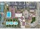Community aerial view featuring multiple pools, tennis courts, and lush landscaping at 5233 N 207Th Dr, Buckeye, AZ 85396