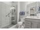 Modern bathroom featuring a glass-enclosed shower and updated fixtures at 5233 N 207Th Dr, Buckeye, AZ 85396