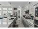 Bright kitchen featuring a large island, stainless steel appliances, and gray cabinets at 5233 N 207Th Dr, Buckeye, AZ 85396