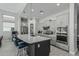 Beautiful kitchen with a large island, stainless steel appliances, and sleek gray cabinets at 5233 N 207Th Dr, Buckeye, AZ 85396