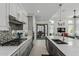Contemporary kitchen with a large island, stainless steel appliances, and open access to the living area at 5233 N 207Th Dr, Buckeye, AZ 85396