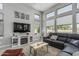 Cozy living room with ample natural light, modern decor, and a large sectional couch at 5233 N 207Th Dr, Buckeye, AZ 85396