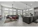 Spacious living room featuring oversized windows, tile floors, and stylish furniture at 5233 N 207Th Dr, Buckeye, AZ 85396